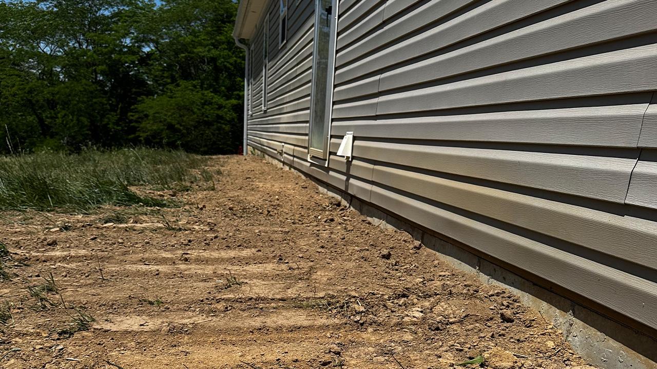 Precision landscape grading Memphis — yard reshaping water flow optimization professional installation