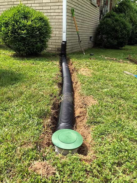 Downspout extensions Memphis — underground system foundation protection residential installation